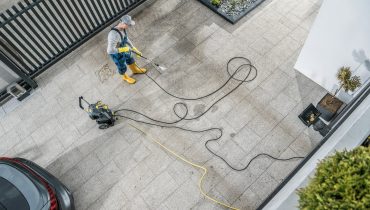 Home Owner Pressure Washing His Dirty Driveway