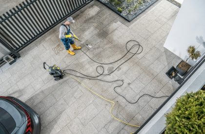 Home Owner Pressure Washing His Dirty Driveway Home Owner Pressure Washing His Dirty Driveway