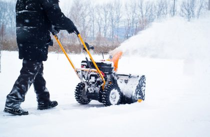 A man cleans snow A man cleans snow